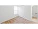 Bright bedroom featuring wood-look vinyl floors, closet, and bathroom at 8521 N 29Th St, Tampa, FL 33604