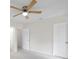 Bright bedroom with carpet, ceiling fan, and doors at 8521 N 29Th St, Tampa, FL 33604