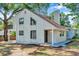 Charming home exterior showcasing a gable roof, white siding, and modern black-framed windows at 8521 N 29Th St, Tampa, FL 33604