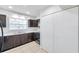 Updated kitchen featuring matching cabinets, sink, window, and tiled floors at 8521 N 29Th St, Tampa, FL 33604