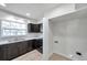 Updated kitchen featuring matching cabinets, sink, window, and tiled floors at 8521 N 29Th St, Tampa, FL 33604