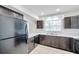 Spacious kitchen featuring black appliances, tile flooring, and cabinets for storage at 8521 N 29Th St, Tampa, FL 33604