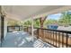 Spacious covered porch with railing and view of neighboring yard and trees at 8521 N 29Th St, Tampa, FL 33604