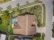 Overhead view of a house highlighting the roof, backyard pool, and paved driveway at 8601 Chadwick Dr, Tampa, FL 33635