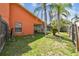 View of backyard featuring an enclosed patio, lush grass, and mature trees at 8601 Chadwick Dr, Tampa, FL 33635