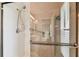Bathroom highlighting a shower with a clear glass door and tiled walls at 8601 Chadwick Dr, Tampa, FL 33635