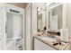 Bathroom features granite vanity with a white sink and cabinetry at 8601 Chadwick Dr, Tampa, FL 33635