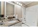 Bathroom features a granite vanity top, white cabinets, and tub with shower at 8601 Chadwick Dr, Tampa, FL 33635
