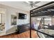 Bedroom has wood flooring, a lofted bed, and a large dresser at 8601 Chadwick Dr, Tampa, FL 33635