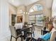 Spacious dining room features large windows, high ceilings, and modern light fixture at 8601 Chadwick Dr, Tampa, FL 33635