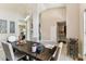 Dining room features a dark wood table and neutral-toned walls and flooring, illuminated by a modern chandelier at 8601 Chadwick Dr, Tampa, FL 33635