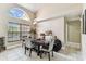 Spacious dining room features large windows, high ceilings, and modern light fixture at 8601 Chadwick Dr, Tampa, FL 33635