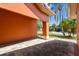 Side of a single-story home featuring a brick driveway with vibrant trees at 8601 Chadwick Dr, Tampa, FL 33635