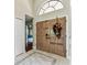 Inviting entryway with double doors decorated for the holidays and tile flooring at 8601 Chadwick Dr, Tampa, FL 33635