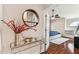 Stylish entryway table with round mirror above, leads into a bedroom with ceiling fan at 8601 Chadwick Dr, Tampa, FL 33635