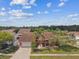 Aerial view of a one-story home with a brick driveway, attached garage, and mature landscaping at 8601 Chadwick Dr, Tampa, FL 33635