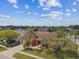 Aerial view of a one-story home with a brick driveway, attached garage, and mature landscaping at 8601 Chadwick Dr, Tampa, FL 33635