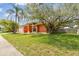Charming single-story home with a mature tree and palm trees in the front yard at 8601 Chadwick Dr, Tampa, FL 33635