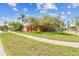 Inviting single-story home with a well-maintained lawn, mature tree and landscaping at 8601 Chadwick Dr, Tampa, FL 33635