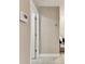 Neutral hallway features tile flooring, light beige walls, and white trim at 8601 Chadwick Dr, Tampa, FL 33635