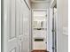 Hallway featuring neutral color, tile floors, leading to a bathroom at 8601 Chadwick Dr, Tampa, FL 33635