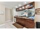 Functional kitchen with dark wood cabinets, granite countertops, and stainless steel dishwasher at 8601 Chadwick Dr, Tampa, FL 33635