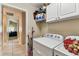 Laundry room boasts side-by-side washer and dryer and overhead cabinet storage at 8601 Chadwick Dr, Tampa, FL 33635
