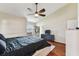 Cozy main bedroom featuring wood floors, ceiling fan, and modern decor at 8601 Chadwick Dr, Tampa, FL 33635