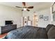 Comfortable main bedroom featuring wood floors, ceiling fan, and access to the bathroom at 8601 Chadwick Dr, Tampa, FL 33635