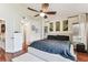Spacious main bedroom features a ceiling fan, wood floors, and a neutral color palette at 8601 Chadwick Dr, Tampa, FL 33635