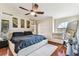 Bright main bedroom with ceiling fan, wood floors, and a comfortable window seat at 8601 Chadwick Dr, Tampa, FL 33635