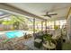 Inviting covered patio area featuring a pool and outdoor furniture at 8601 Chadwick Dr, Tampa, FL 33635