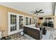 Inviting covered patio featuring a ceiling fan, comfortable seating, and multiple access points to the home at 8601 Chadwick Dr, Tampa, FL 33635