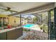 Screened-in patio with a view of the swimming pool, perfect for outdoor relaxation and entertainment at 8601 Chadwick Dr, Tampa, FL 33635