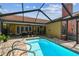 Backyard pool and patio area, offering a relaxing outdoor space with privacy and leisure at 8601 Chadwick Dr, Tampa, FL 33635