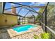 View of a sparkling blue swimming pool inside a screened enclosure, offering a private outdoor oasis at 8601 Chadwick Dr, Tampa, FL 33635