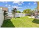 Side yard with healthy lawn and white vinyl fencing at 8601 Chadwick Dr, Tampa, FL 33635