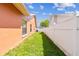 Narrow side yard with privacy fence and lawn at 8601 Chadwick Dr, Tampa, FL 33635