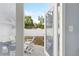 Serene backyard view through glass doors, showcasing a peaceful outdoor seating area perfect for relaxation and enjoyment at 914 E North St, Tampa, FL 33604