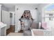 Bedroom with chair, bassinet, closet, wood floors, and natural light at 914 E North St, Tampa, FL 33604