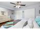 Light and airy bedroom featuring wood floors, ceiling fan, and ensuite closet at 914 E North St, Tampa, FL 33604