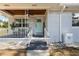 Inviting front porch features a wood ceiling, charming railings, and a cozy seating area at 914 E North St, Tampa, FL 33604