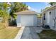 Detached garage with a white door and driveway, complementing the home's exterior at 914 E North St, Tampa, FL 33604