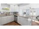 Bright kitchen boasts granite countertops, stainless steel appliances, and white cabinetry, seamlessly flowing into the living area at 914 E North St, Tampa, FL 33604