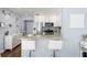 Kitchen bar seating offers an inviting view of the stainless steel appliances and elegant marble-look buffet, enhancing the living space at 914 E North St, Tampa, FL 33604