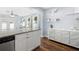 Open-concept design connects the kitchen, featuring white cabinets and granite countertops, to the cozy living area with modern decor at 914 E North St, Tampa, FL 33604