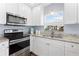 Well-equipped kitchen showcases stainless steel appliances, ample cabinet space, and granite countertops under soft, natural light at 914 E North St, Tampa, FL 33604