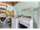 Functional laundry area with modern washer and dryer, ample storage, and laundry-themed decor at 914 E North St, Tampa, FL 33604