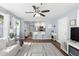 Spacious living room with natural light, showcases kitchen access, stylish decor, and comfortable seating, perfect for relaxation at 914 E North St, Tampa, FL 33604