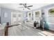 Sunlit living room features hardwood floors, white furnishings, and elegant decor, creating a welcoming and stylish ambiance at 914 E North St, Tampa, FL 33604
